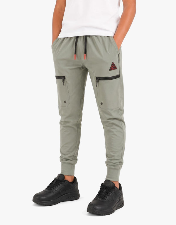 Vello Boys Trackpants in olive green, featuring cargo pockets and an elasticated waist, modeled by a young boy.