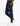 navy track pants with drawstring waist, zip pockets and cargo pocket, small circular logo patch on thigh, paired with white