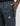 dark blue track pants with a zippered side pocket and a hex badge logo.