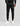 man in black track pants with zip pockets and a hex logo patch on the thigh, cuffs at the ankle, white sneakers
