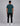 back view of a man wearing teal short sleeve t shirt and black cargo pants with white sneakers