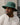 Castelli green bucket hat with a wide brim and chin cord, logo patch on the front.