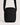 black compact sling bag with a textured fabric and adjustable strap against a light neutral background