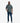man in a green oversized short sleeve t shirt with a circular logo on the chest, paired with blue denim jeans and black and