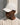 beige baseball cap with white embroidered logo on the side, curved brim, worn by a person in a matching beige sweatshirt