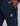 navy track pants with zip pockets and a small hex logo patch on the thigh