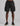 black cargo shorts by k star seven signature with elastic waist and drawstring, side flap pockets, left leg logo, worn with