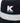 Close-up of a navy Klevas Martina Reversible Bucket Hat featuring a white embroidered 'K Klevas' logo and a white band with