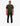 Full body shot of a male model wearing a dark green Louis Mens Knitted Golfer polo shirt, black jeans, and white sneakers.