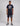 man in navy short sleeve t shirt with nasa graphic and navy shorts featuring rocket emblem; grey sneakers visible