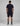 back view of a man wearing a navy short sleeve t shirt and matching navy shorts from a two piece set by K-Star 7 Originals