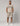 man wearing beige two piece set with navy trim, short sleeve tee and knee length shorts with originals branding