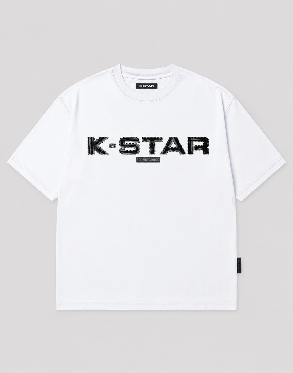 white oversized short sleeve t shirt with a bold distressed black k-star graphic and a small iconic goods label