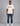 man wearing a cream short sleeve t shirt with a red white and blue logo from K-Star 7 Originals with distressed blue jeans