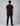 back view of a man in a black short sleeve t shirt with orange trim at the neckline and sleeve cuffs, paired with black