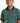 A young boy wearing a green Tito boys polo shirt with graphic prints and a black and orange collar.